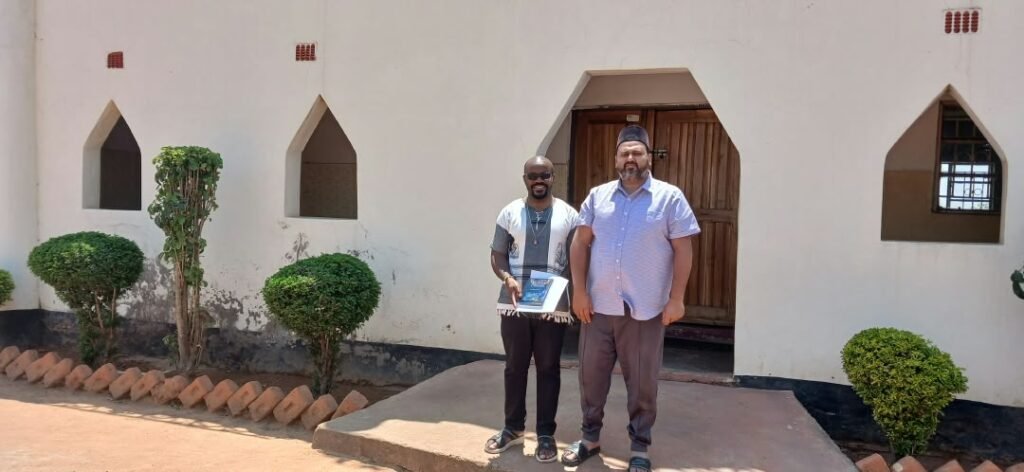 Fr. Remmy Banda and Imam Faiz Yaqoob at the entrance of the Ahmadiyya Mosque, Pemba