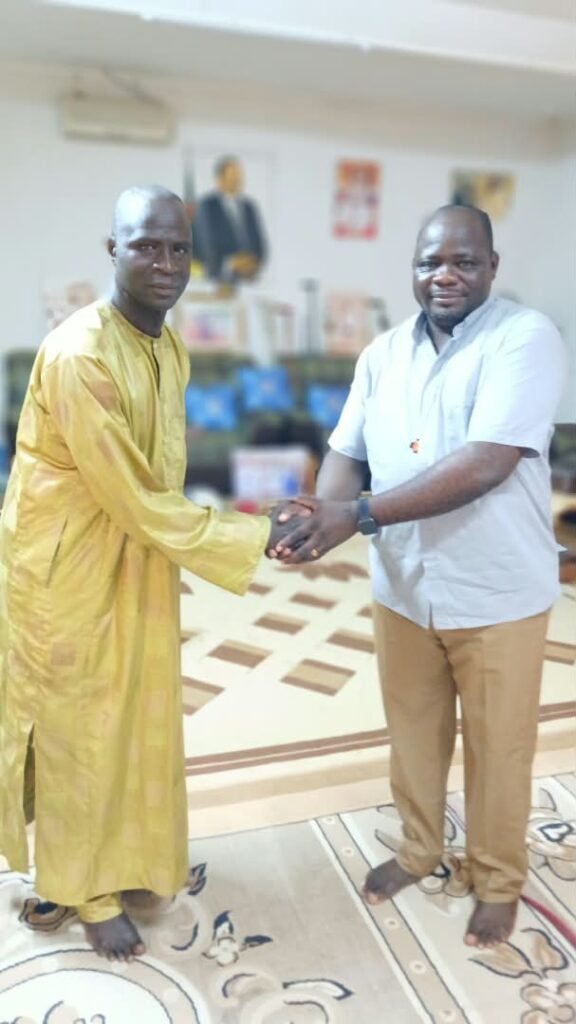 Handshake between Fr François Awono Ntsongo and a notable of the canton of Mokong