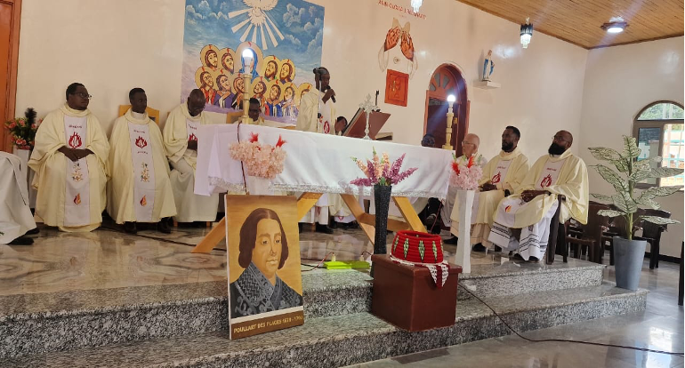 Portrait of Founder Claude-François Poullart des Places displayed in front of the altar during the Eucharistic celebration.