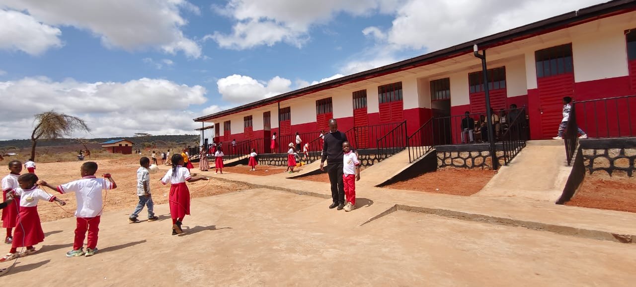 A Spiritan priest with a pupil outside the new classrooms in Yabello